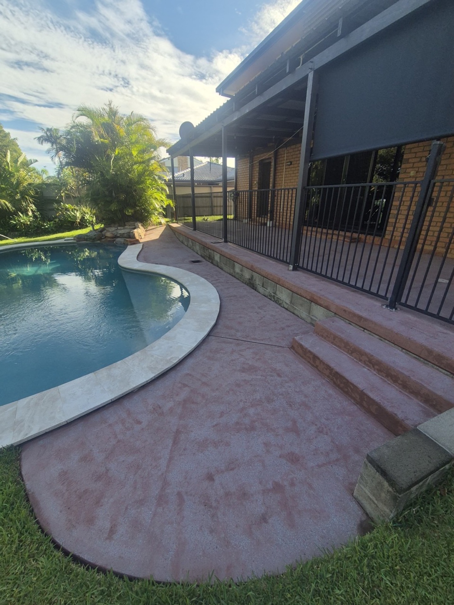 Pool area before covercrete resurfacing in Greystone with black and white fleck